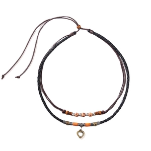 Retro double-layer necklace with wooden beads and bronze heart pendant on white background