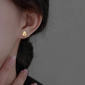 Elegant 18k gold plated gourd-shaped stud earrings with scale texture on model