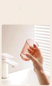 Amber toothbrush cup with vertical ribbing texture on a modern bathroom countertop