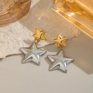 Macro detail of bicolor star stud earrings in polished gold and silver stainless steel
