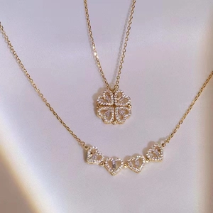 Detailed view of foldable magnetic four-leaf clover necklace with sparkling heart charms