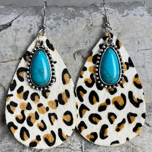 Detail view of teardrop earrings featuring leopard print hair and turquoise stone inlay