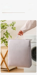 Detail of grey honeycomb mesh laundry bag with wide reinforced handle and zipper closure