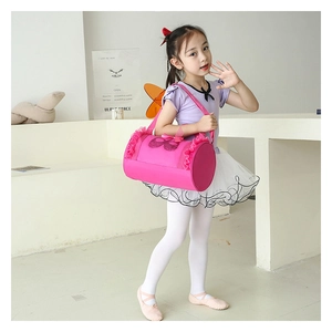 Close-up of pink girls ballet bag featuring lace trim and a decorative mesh bow detail