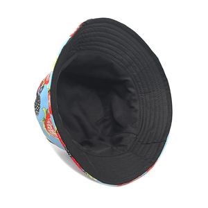 Detail of reversible bucket hat showing strawberry fruit print and black inner lining