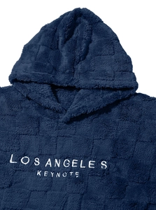 Close-up of Los Angeles white embroidery on soft blue fleece hoodie material