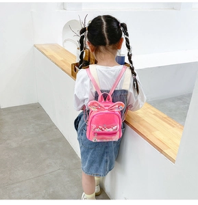 Pink girls backpack with glitter sequins and cute bunny ears detail shown on a model