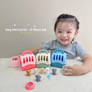 Toddler playing with toy dog kennel set including colorful baskets and plush puppies