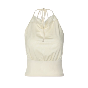 Detail of cream halter top featuring lace patchwork and slim waist tie design
