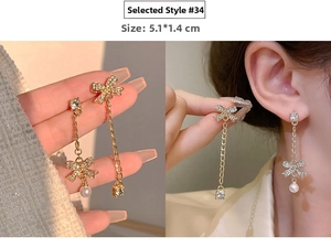 Close-up of asymmetric tassel earrings with bowknots and pearls, sized 5.1x1.4cm