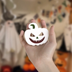 Macro shot of Halloween evil pumpkin pendant showing product size and matte resin texture