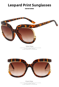 Close-up of oversized leopard print sunglasses with gold metal trim and brown lenses
