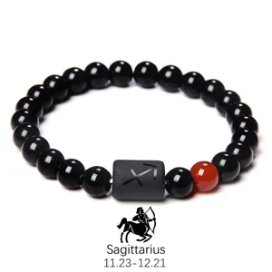 Detail of Sagittarius obsidian beaded bracelet with engraved zodiac symbol bead