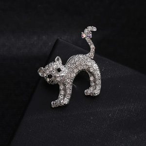 Sparkling crystal cat brooch pin in silver finish featuring elegant feline design