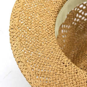 Detail of hand-woven straw hat showing breathable khaki texture and sweatband inside