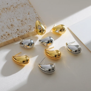 Minimalist hollow teardrop earrings in gold and silver with cubic zirconia inlays