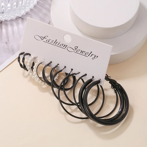 Detail view of 6-pair fashion earring set featuring black C-shape hoops and pearl studs