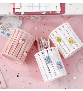 Close-up of three woven texture plastic pen holders with cute peach, durian and bear charms