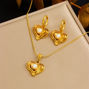 Gold plated heart jewelry set with necklace and earrings featuring white pearls