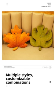 Detail of plush leaf pillows with cute faces on a beige sofa, featuring maple shapes