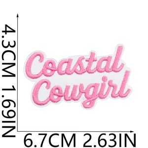 Detail view of pink and white Coastal Cowgirl embroidered patch showing 6.7x4.3cm dimensions