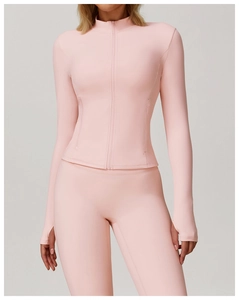 Detail view of pink yoga jacket with zipper, high collar and functional thumbhole cuffs
