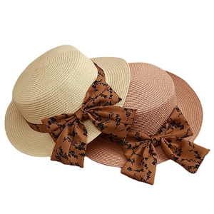 Elegant flat top straw boater hats for women featuring vintage floral ribbon bows