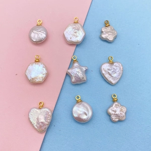 Macro view of natural white freshwater pearl charms in heart and star shapes for jewelry