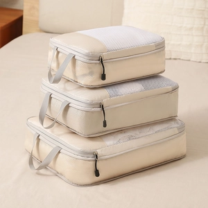 Beige 3-piece compression travel organizer set with breathable mesh and handles