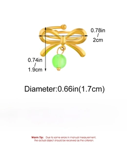 Detail view of a gold bow ring with green bead showing 1.7cm inner diameter measurements