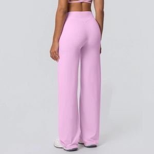 Macro view of light pink high-waisted wide-leg yoga pants with premium soft fabric detail