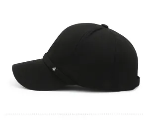 Side view of black cotton baseball cap with curved brim and metal shield emblem detail