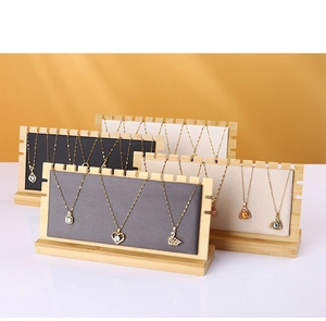 Bamboo necklace display stands with multi-color fabric inserts showing various pendants