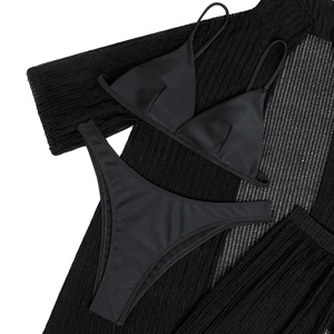 Flat lay of black four-piece bikini set with sheer mesh knit beach cover-up texture details