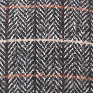Macro shot of wool blend herringbone fabric with orange windowpane check for newsboy caps