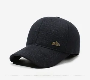 Detailed side view of navy blue fleece-lined winter baseball cap with mountain metal badge