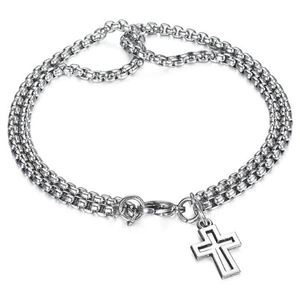 Macro detail of silver double-layered stainless steel chain bracelet with cross charm