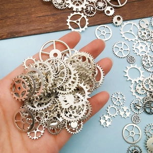 Macro view of assorted silver metal steampunk gears and vintage clockwork pendants