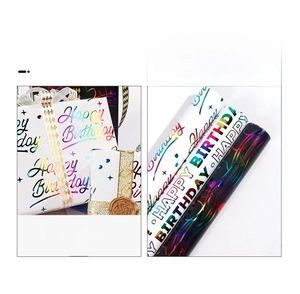 Detail of colorful gold stamping Happy Birthday gift wrap rolls with metallic finish