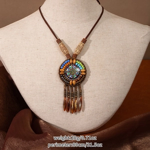 Close-up of Bohemian ethnic long necklace with wooden beads and a colorful resin pendant