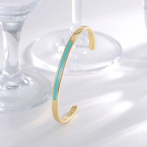 Minimalist adjustable open gold bracelet with light blue enamel inlay and C-shaped design