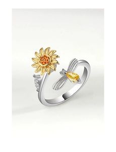 Macro detail of rotating sunflower ring with bee accent and sparkling yellow gemstones