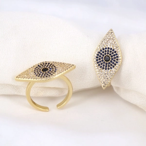 Macro detail of gold evil eye ring with blue and white zircon micro-pave stones