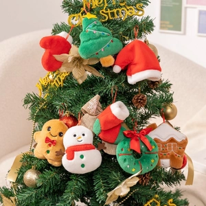 Festive plush Christmas ornaments including gingerbread man and tree hanging on a tree