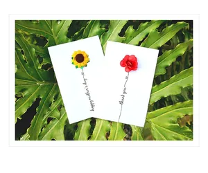 Detail of 3D handmade floral greeting cards with sunflower and rose on white paper