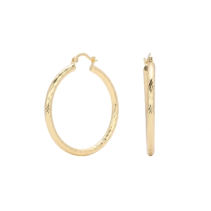 Detailed macro view of S925 sterling silver stamp on golden twisted hoop earrings