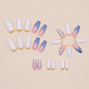 Coffin shaped press-on nails set with gold french tips and blue glitter accents