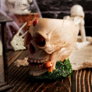 Gothic skull planter with moss and orange mushrooms for Halloween resin decoration