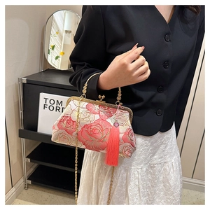 Detail of pink peony embroidery on shell-shaped crossbody bag with silk tassel