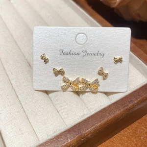 Detailed close-up of bow knot stud earrings set with sparkling white cubic zirconia stones
